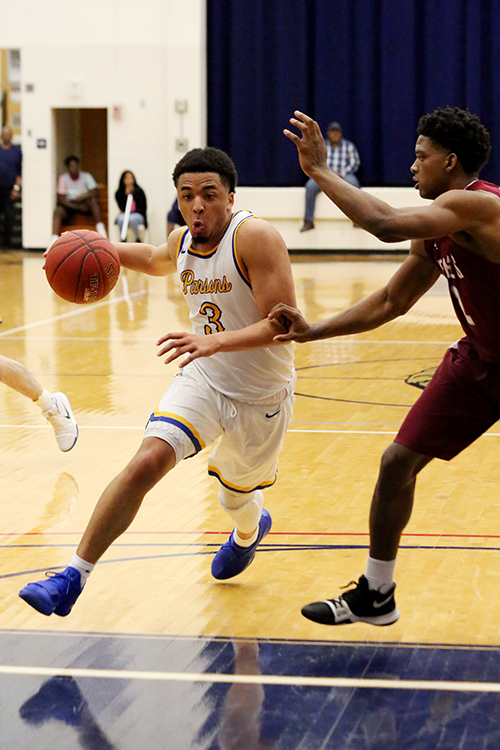 Snead State basketball player Trai James dribbling the ball.